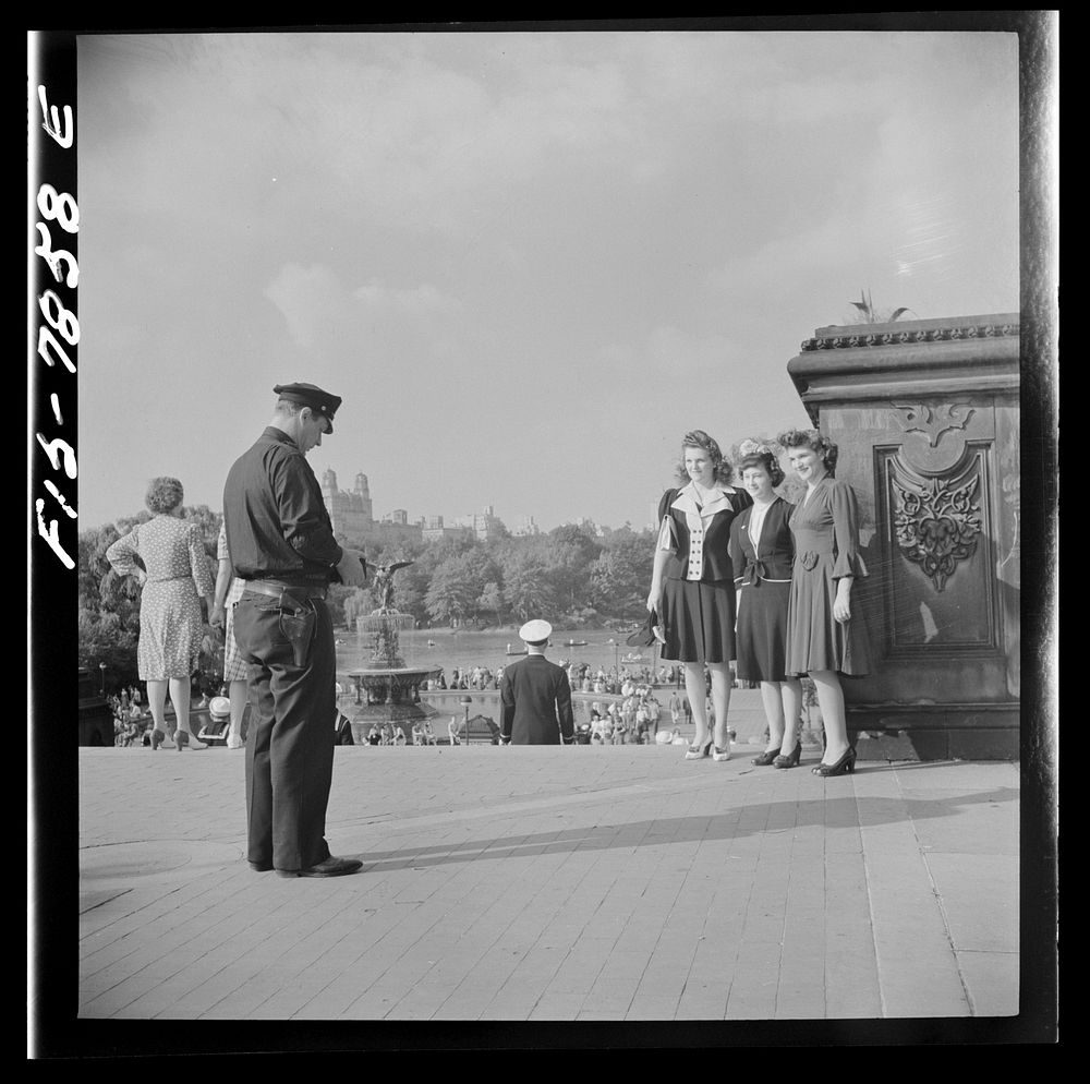 New York, New York. Policeman obliges three Sunday stroller in Central Park by taking their photographs. Sourced from the…