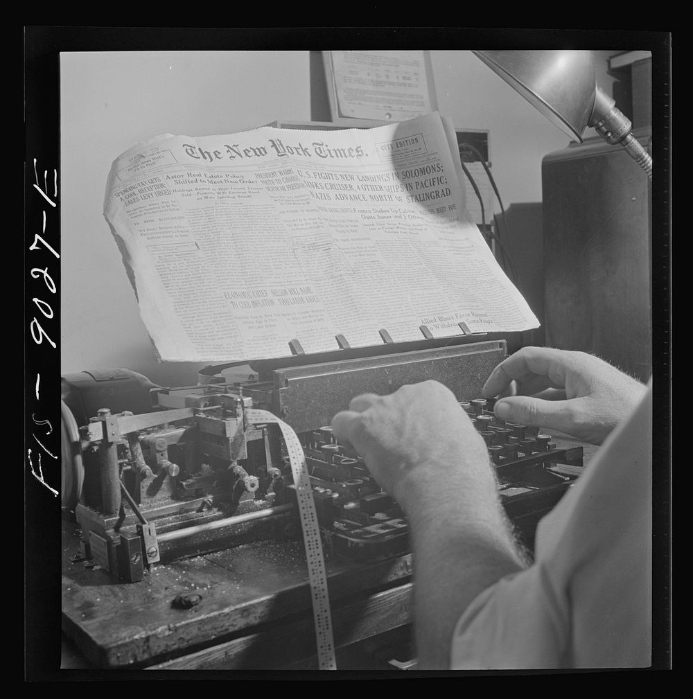 New York, New York. Radio room of the New York Times newspaper. Times news passed by naval censor (see stamps on paper) is…