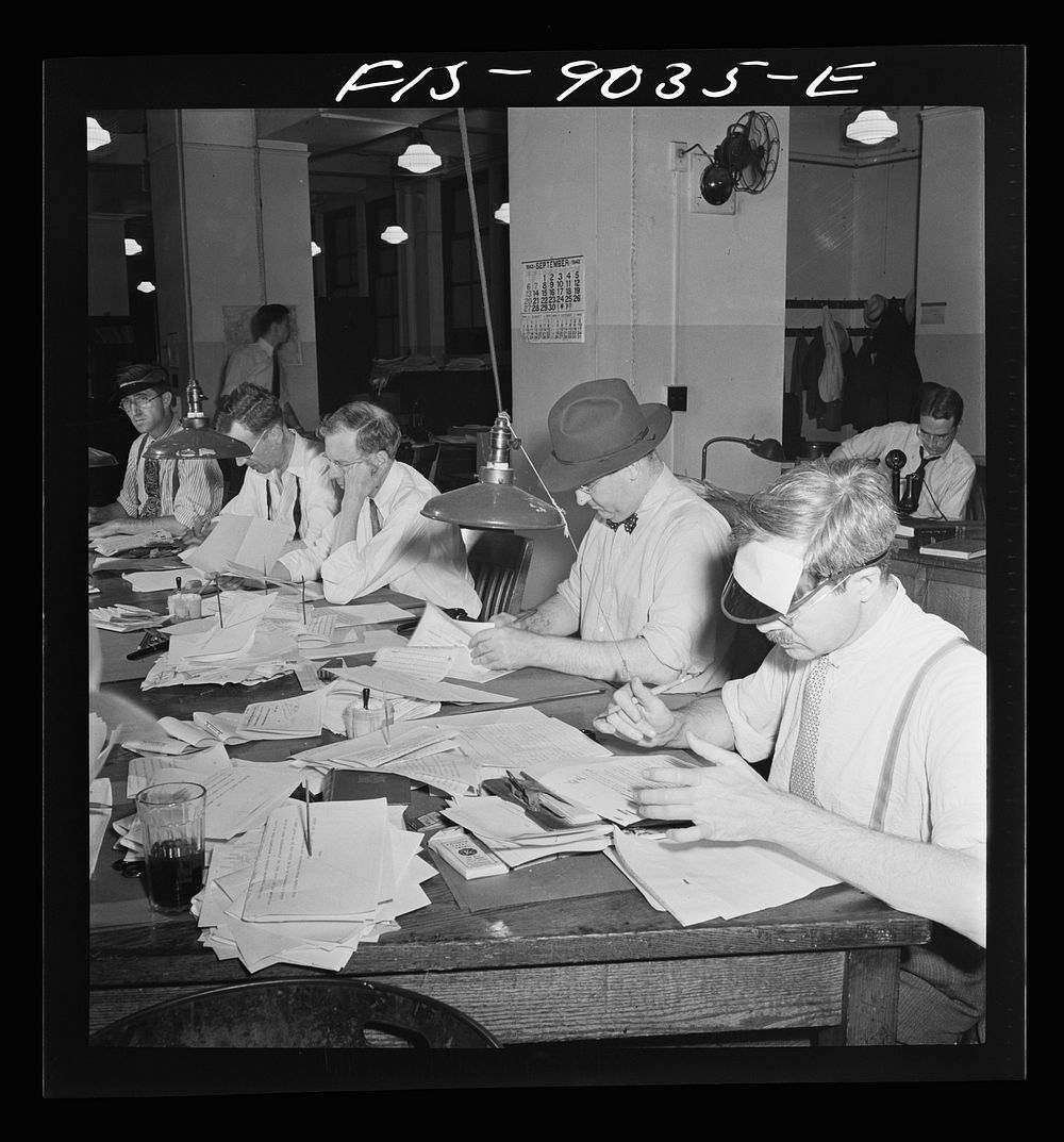 New York, New York. Newsroom of the New York Times newspaper. Copy readers at the telegraph desk which handles all…