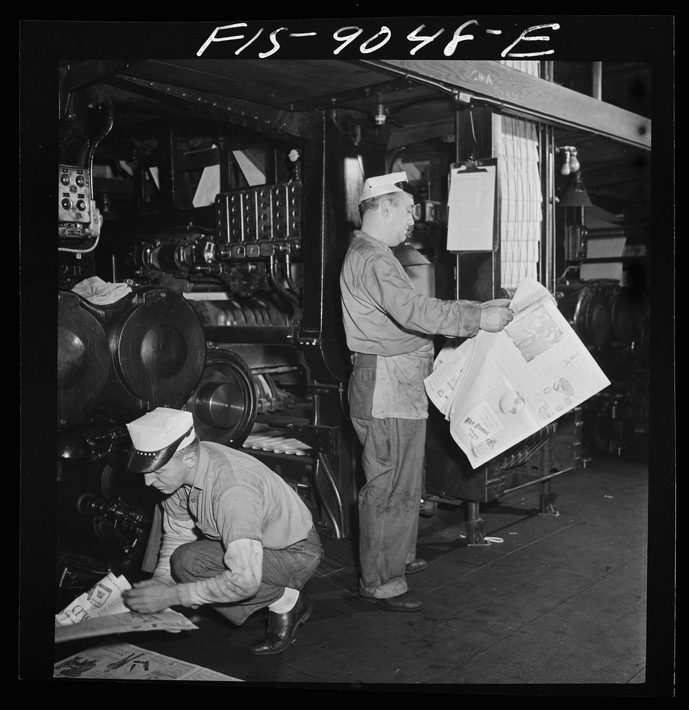 New York, New York. Pressroom of the New York Times newspaper. As presses are rollig and finished papers start coming off…