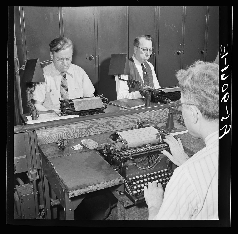 New York, New York. Wire room of the New York Times newspaper. Telegraphers receive and record messages received by Western…