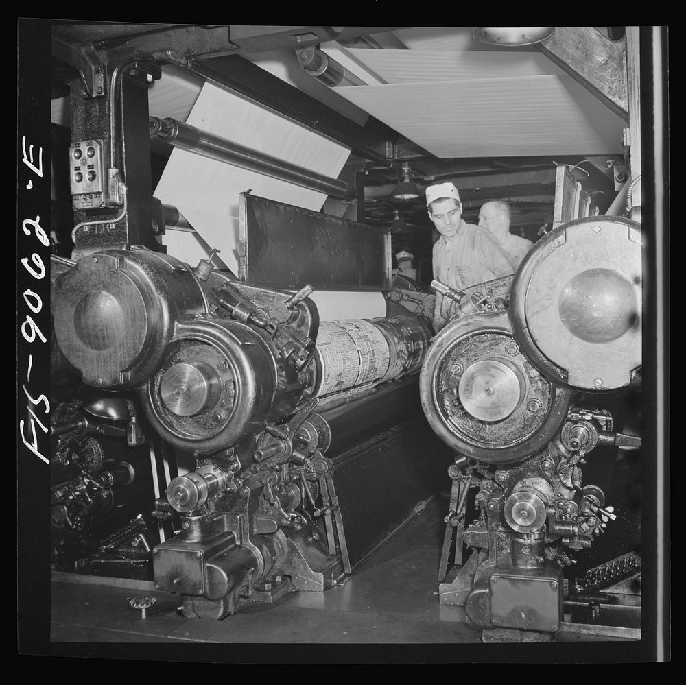 New York, New York. Pressroom of the New York Times newspaper. Putting plates into presses before they start rolling.…