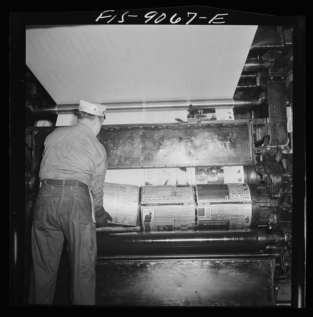New York, New York. Pressroom of the New York Times newspaper. Placing plates on cylinder of press. Sourced from the Library…