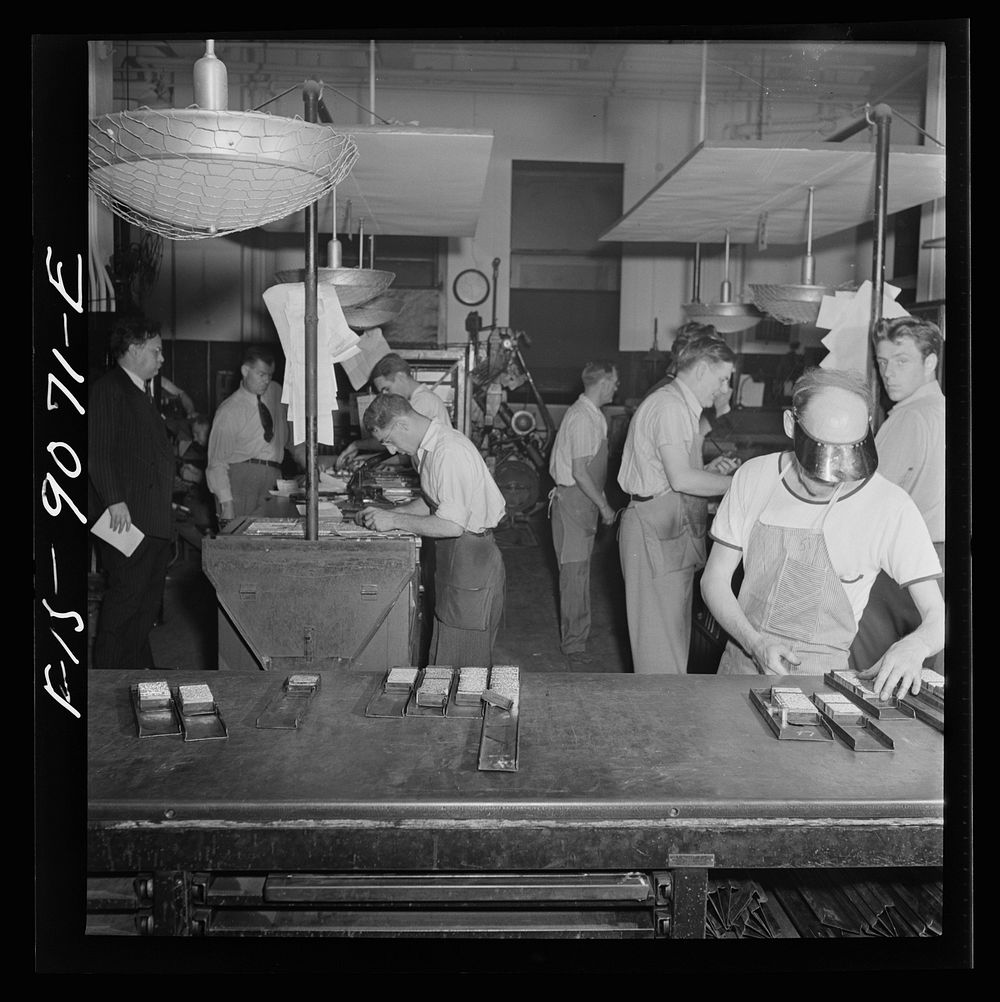 New York, New York. Composing room of the New York Times newspaper. Make-up men pick up linotype slugs from center table.…