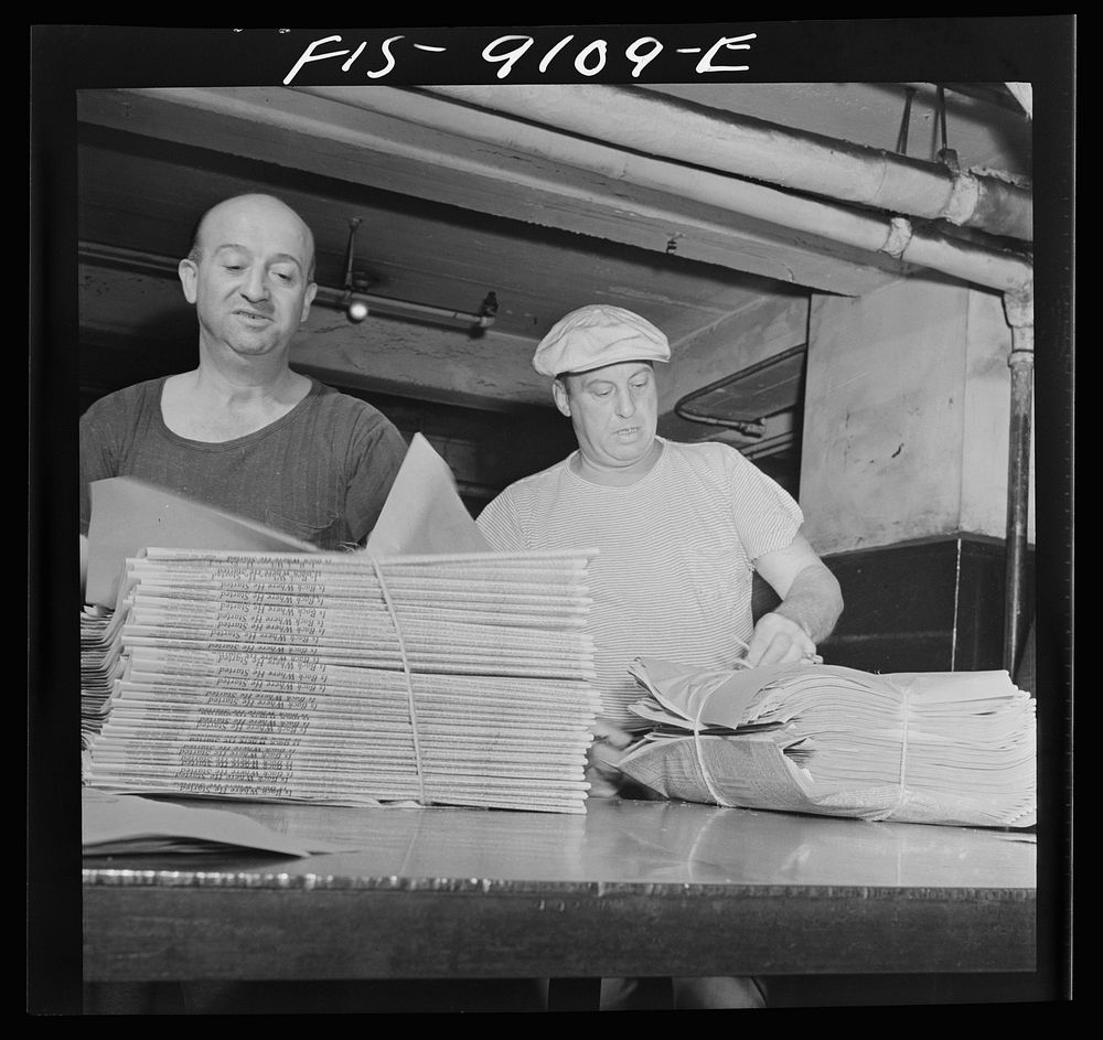 New York, New York. Mailroom of the New York Times newspaper. After arriving on a conveyor from the press room, papers are…