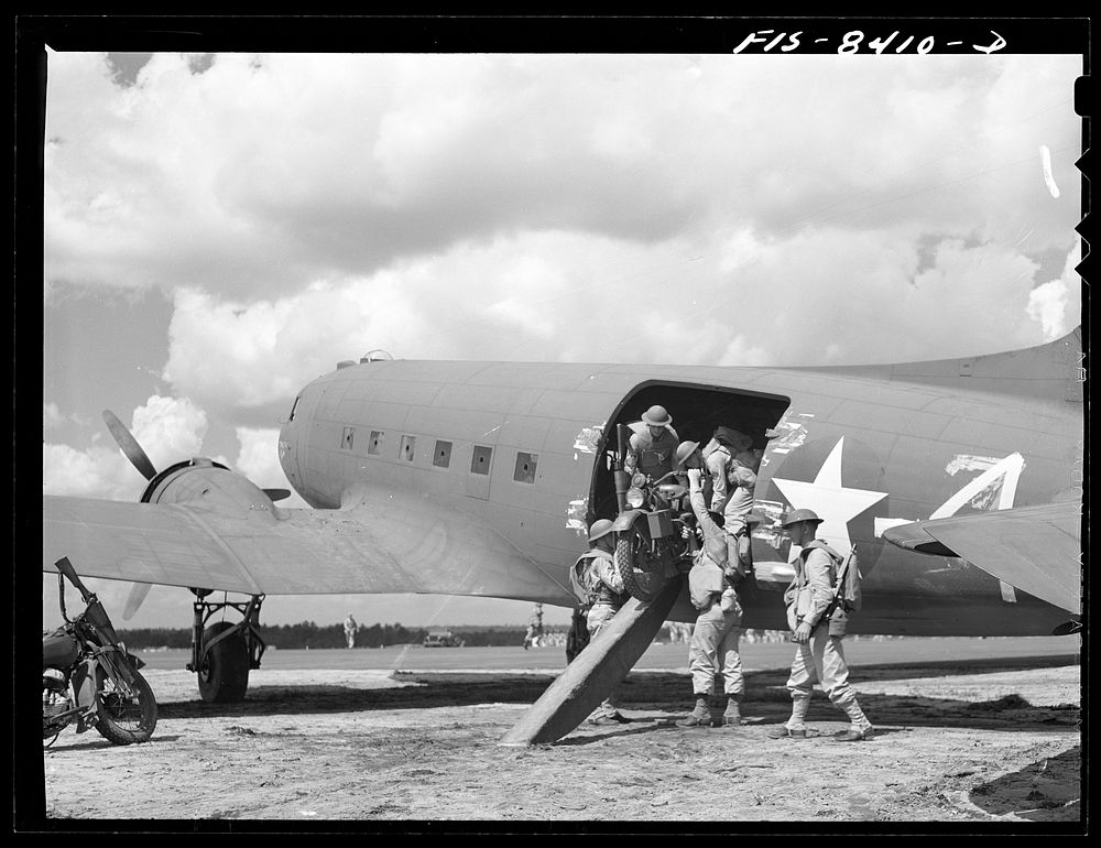 Fort Bragg, North Carolina. Airborne motorcyclists leaving a transport plane in a military demonstration. Sourced from the…