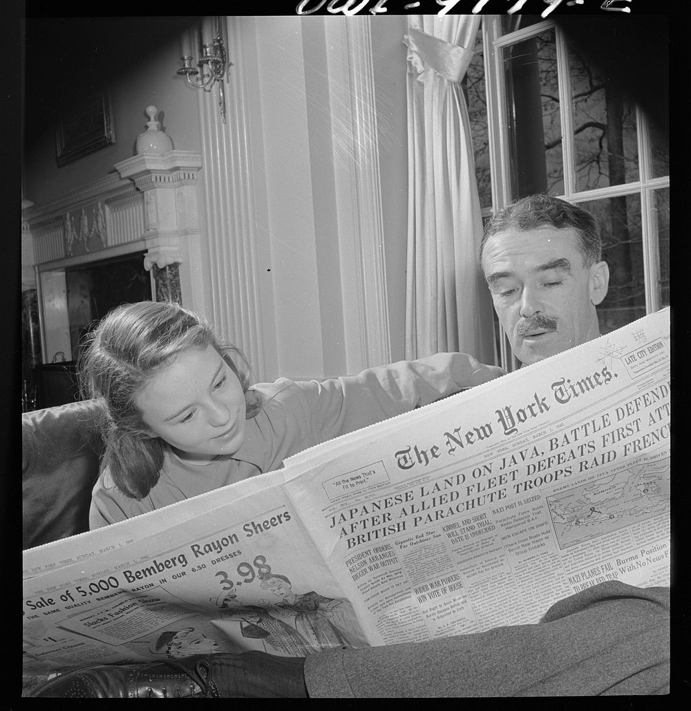 Washington, D.C. The Australian Legation. Minister Casey reading the newspaper to his dayghter Jane. Sourced from the…