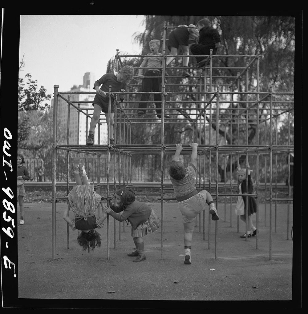 New York, New York. Janet and Marie Wynn [or Winn] (lower left), Czech-American children, climbing on monkey bars in Central…