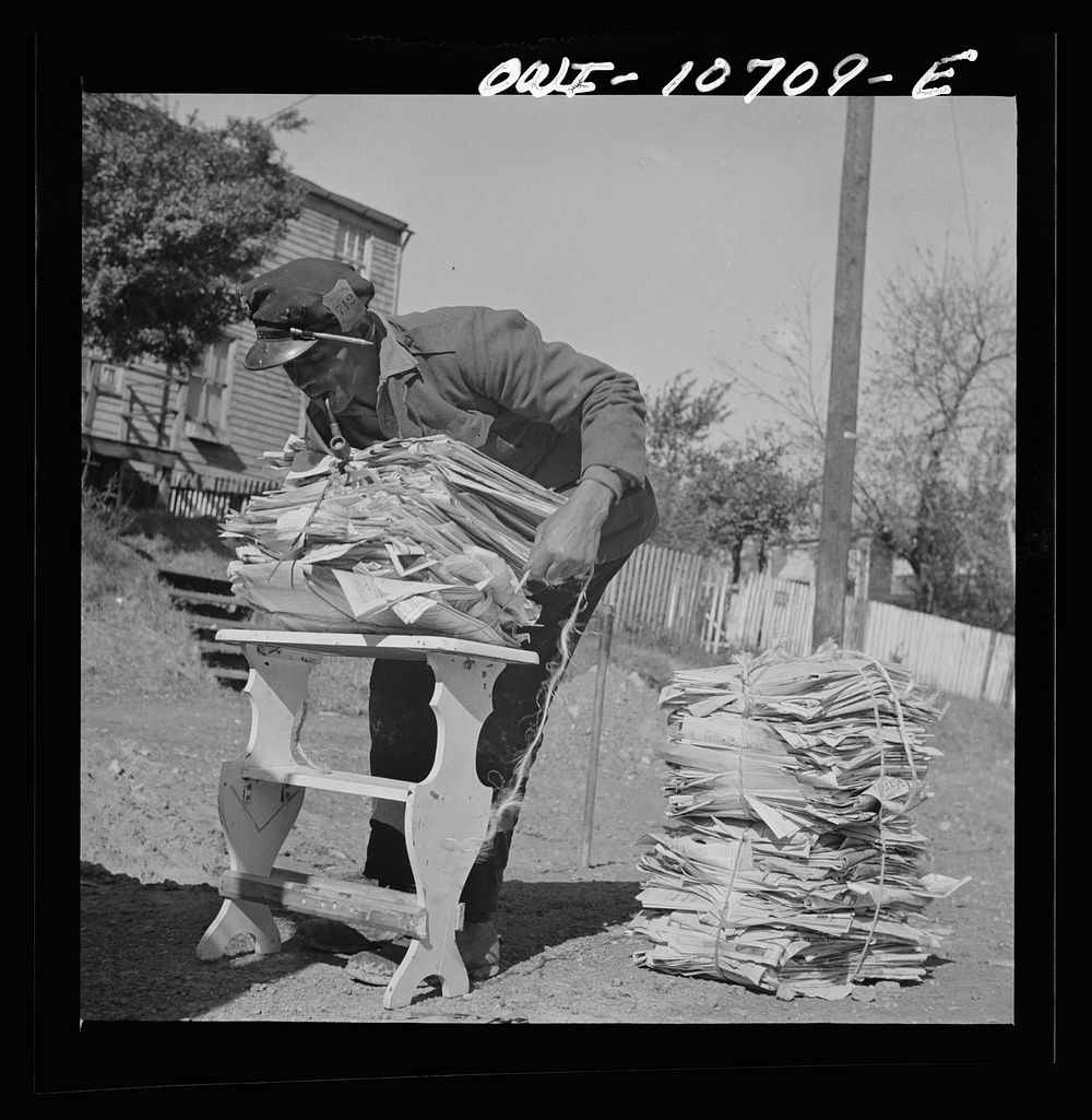 Washington, D.C. Mr. Venus Alsobrook, official salvage collector for the government wrapping old papers which he has…