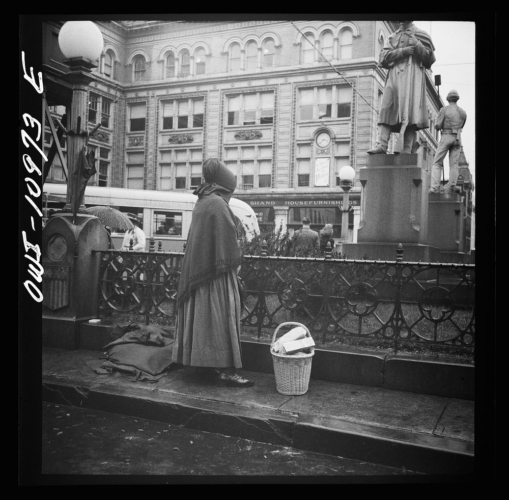 Lancaster, Pennsylvania. Mennonite woman waiting for a bus on a rainy market day. Sourced from the Library of Congress.