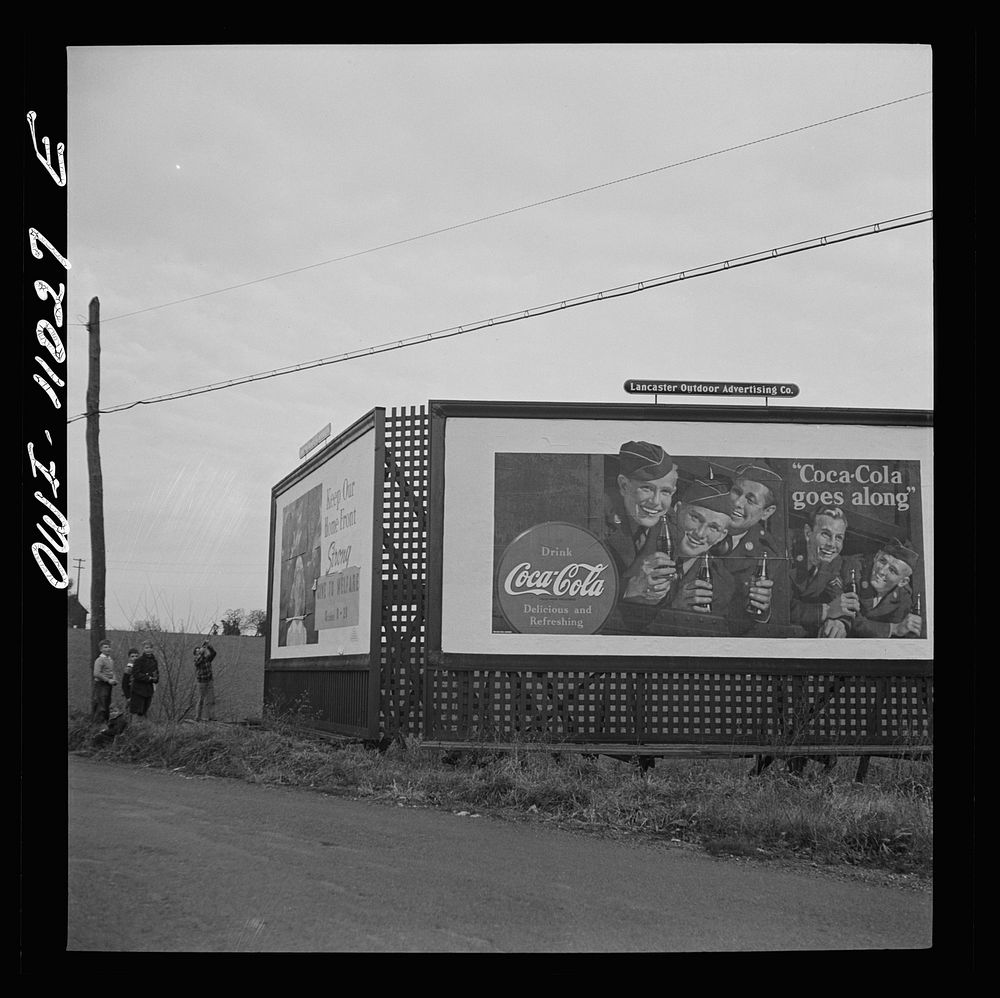 [Untitled photo, possibly related to: Lititz (vicinity), Pennsylvania. Boys playing near a billboard. Most of their fathers…