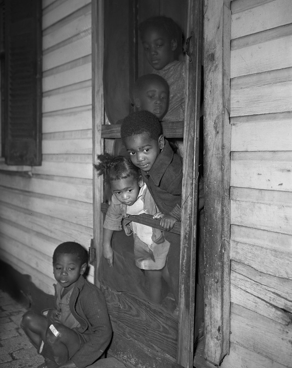 Washington (southwest section), D.C.  children in the front door of their home. Sourced from the Library of Congress.