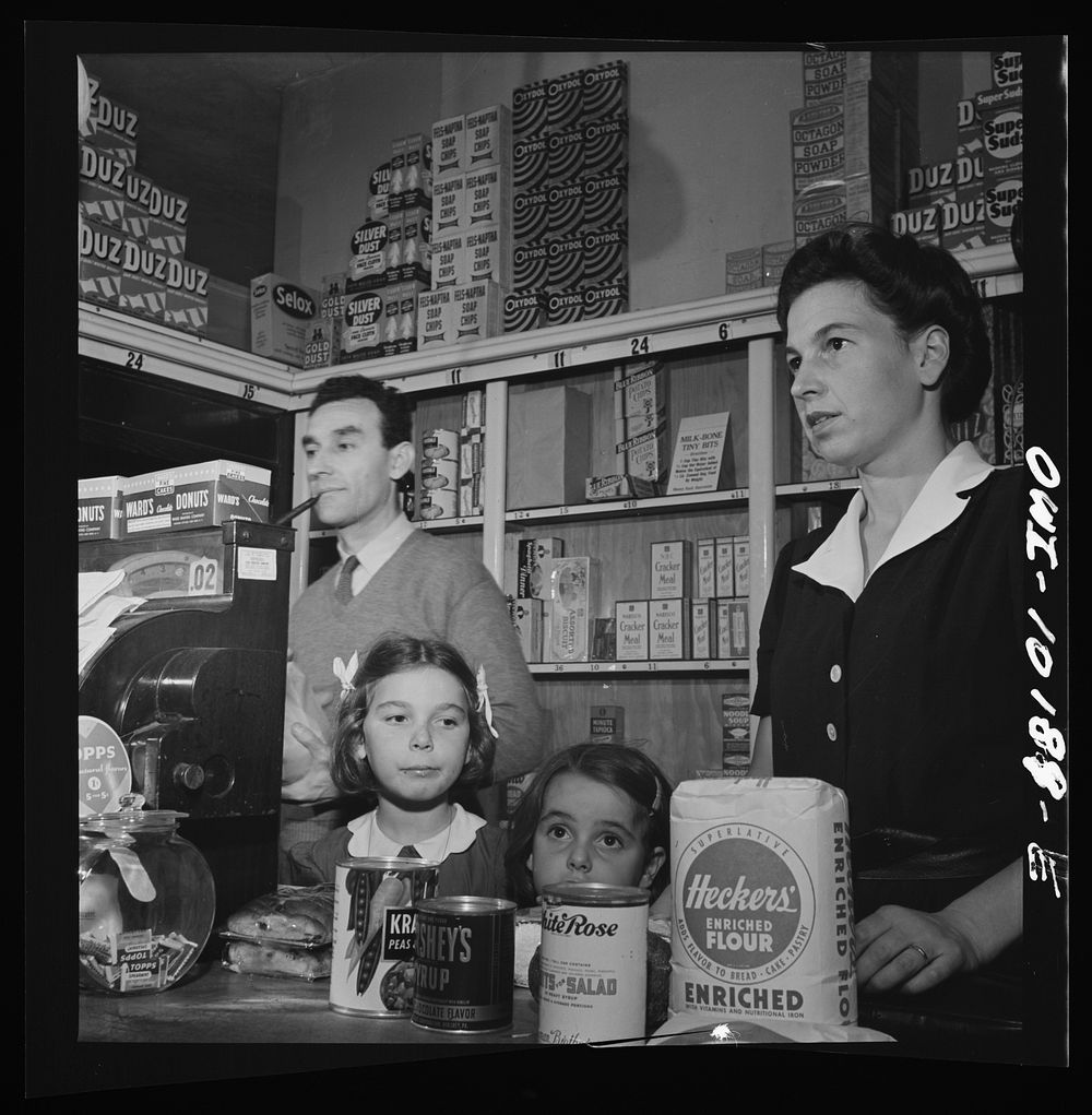 New York, New York. A Czech doctor's wife, Mrs. Winn [or Wynn], and her two daughters shopping for groceries. Sourced from…