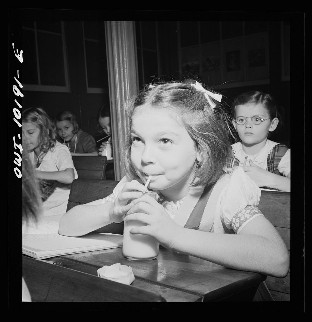 New York, New York. A Czech physician's older daughter, Janet Winn [or Wynn], having morning milk in public school. Sourced…