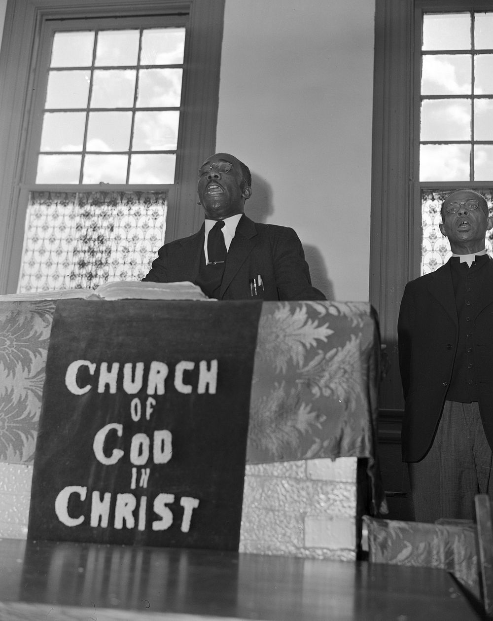 Washington, D.C. Elder Kelsey, pastor of the Church of God in Christ, opening a service with a song. Sourced from the…