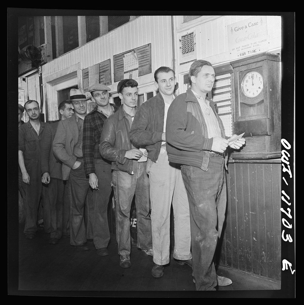 Lititz, Pennsylvania. Employees in the Animal Trap Company machine shop checking out for lunch. Sourced from the Library of…