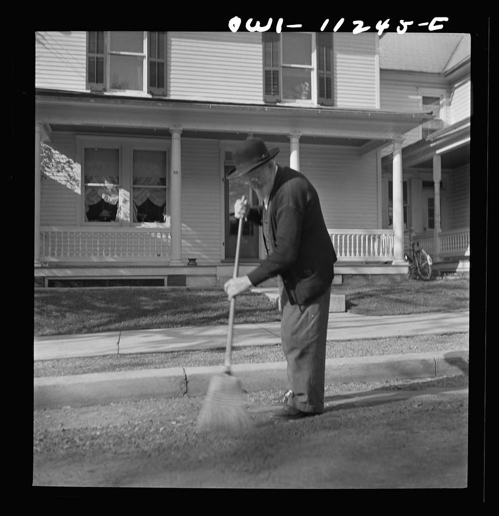 [Untitled photo, possibly related to: Lititz, Pennsylvania. Old Mennonite sweeping leaves]. Sourced from the Library of…