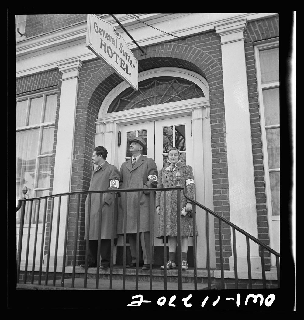 [Untitled photo, possibly related to: Lititz, Pennsylvania. Air raid wardens and Red Cross worker on duty outside a hotel…
