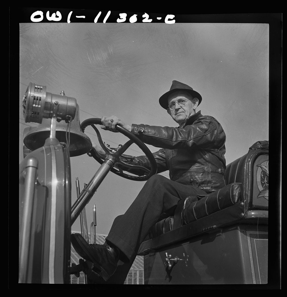 Lititz, Pennsylvania. This man has been a volunteer fire engine driver for twenty-three years. Sourced from the Library of…
