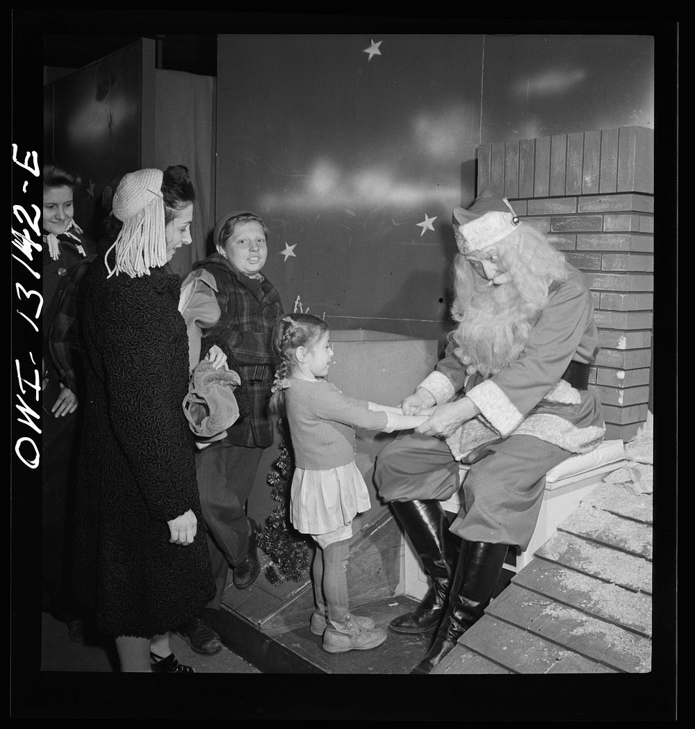 New York, New York. R. H. Macy and Company department store during the week before Christmas. Children line up to talk with…