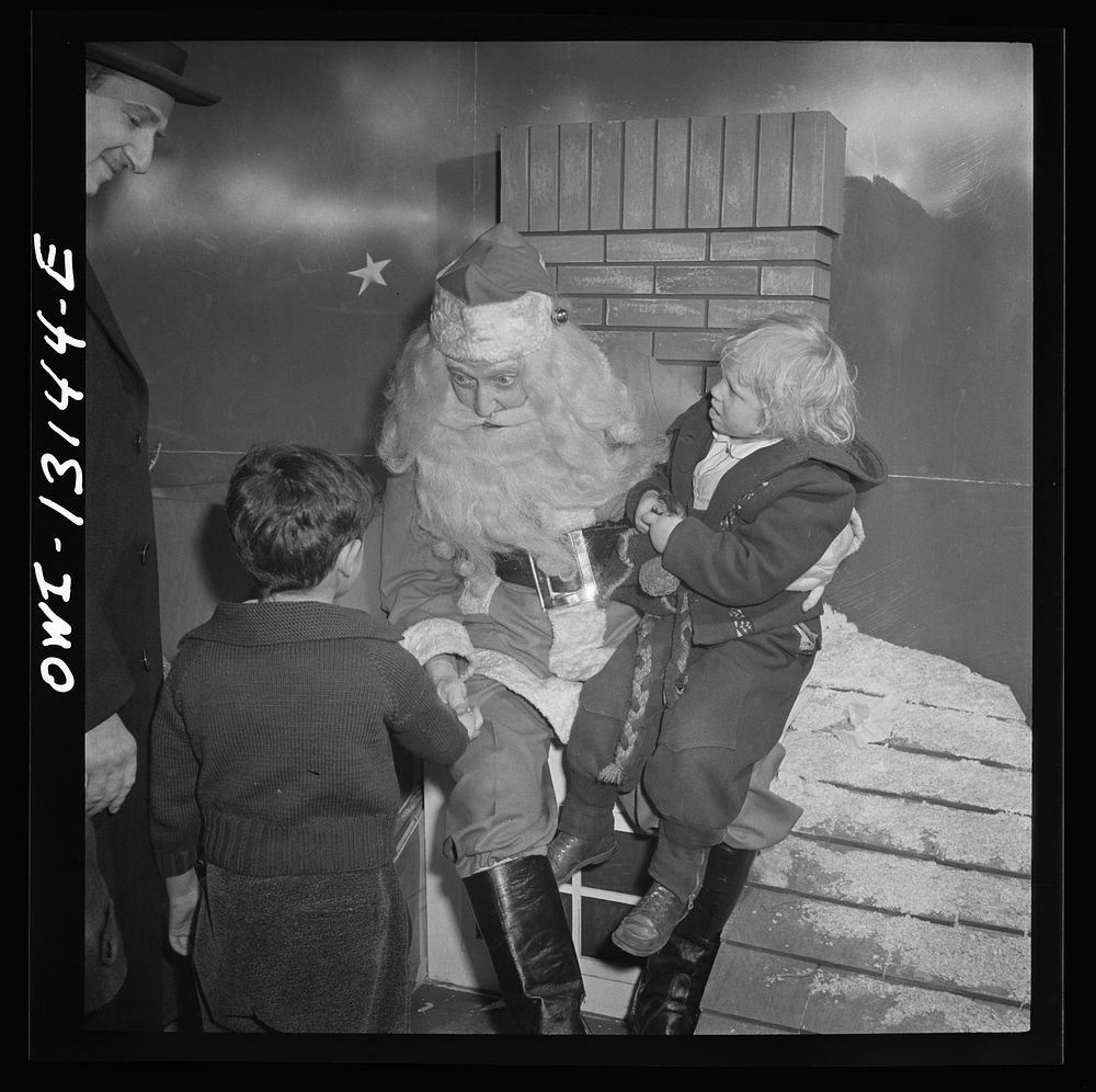 New York, New York. R. H. Macy and Company department store during the week before Christmas. Children line up to talk with…