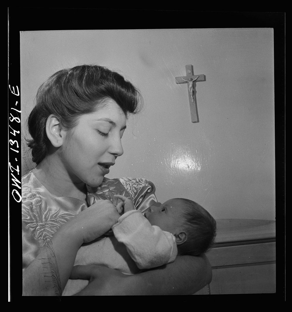 New York, New York. Mrs. Frank Romano and her month-old son Benny. Her husband works in the Brooklyn Navy Yard. Sourced from…