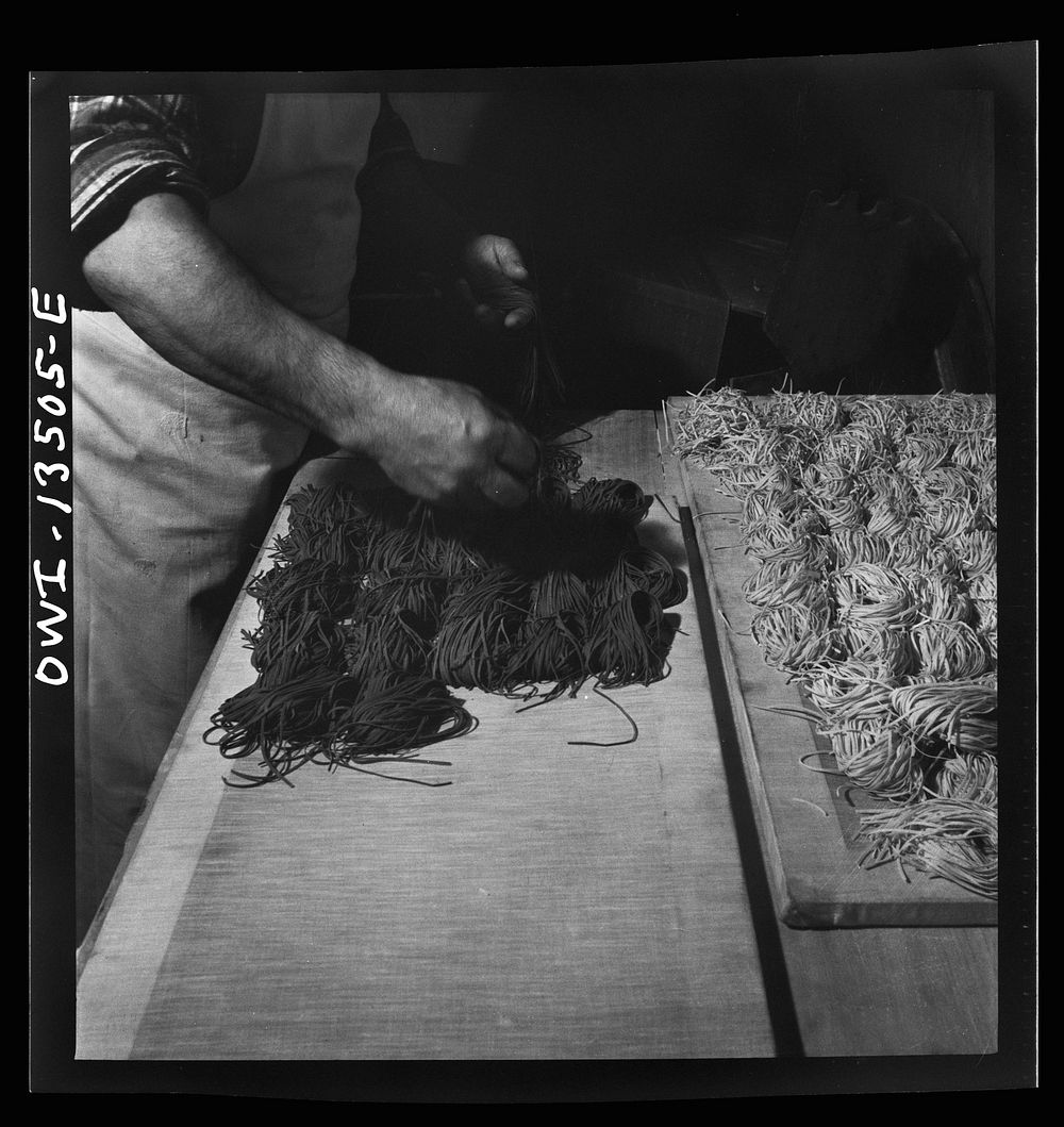 [Untitled photo, possibly related to: New York, New York. Laying out portions of freshly-made green and white noodles in the…