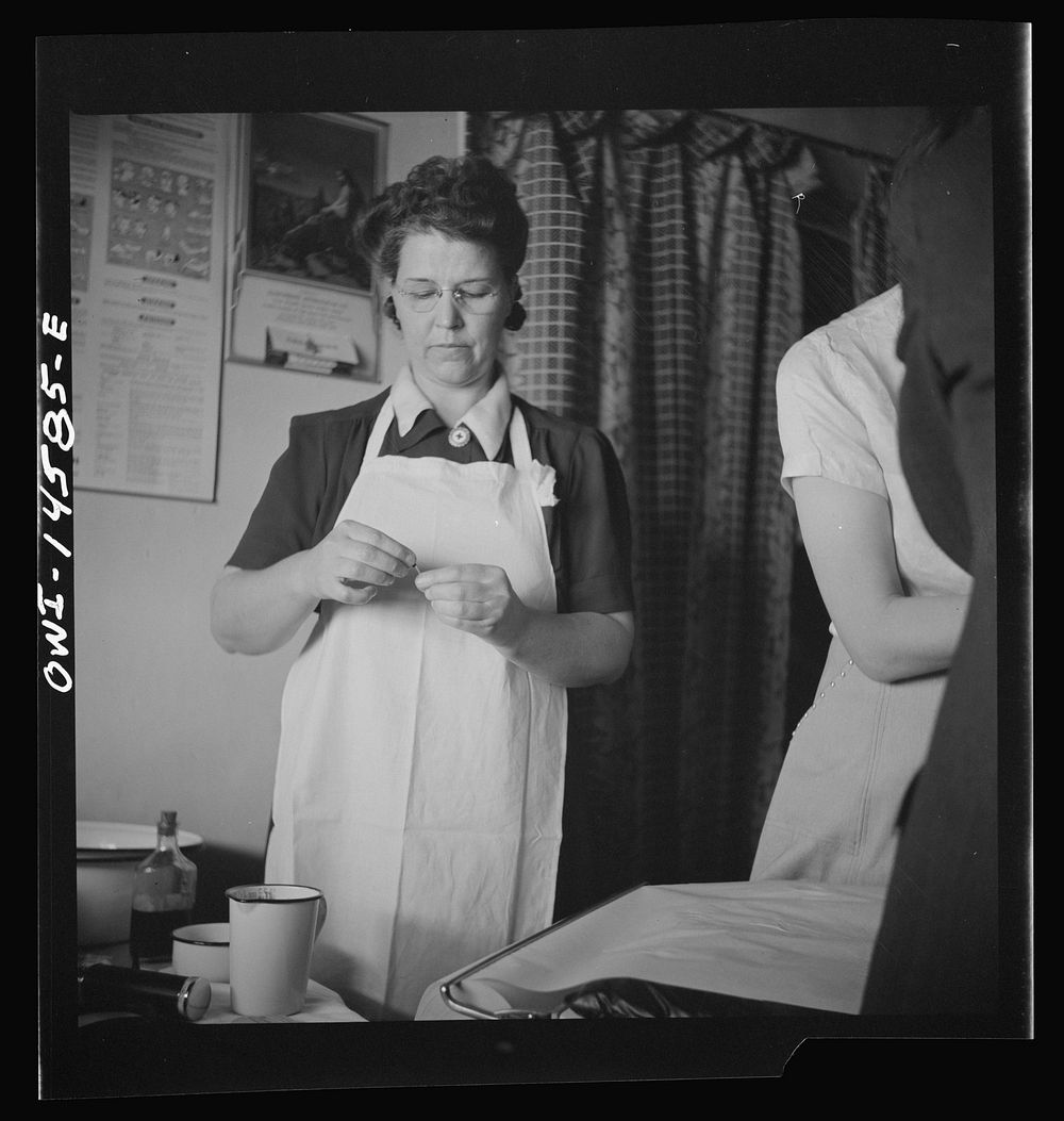 Penasco, New Mexico. Taos County public health nurse assisting in the clinic. Sourced from the Library of Congress.
