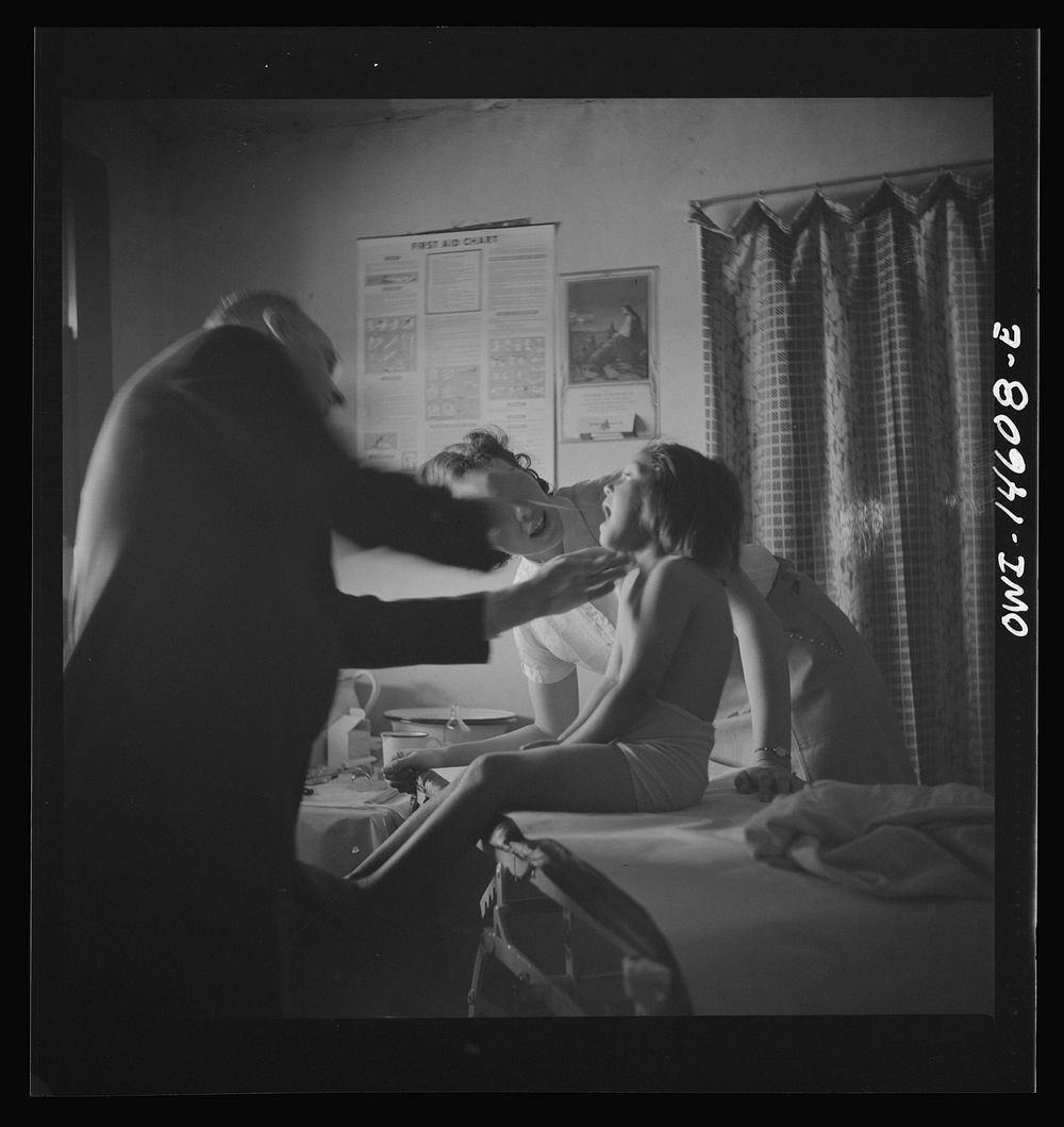 [Untitled photo, possibly related to: Penasco, New Mexico. Taos County public health nurse assisting in the clinic]. Sourced…