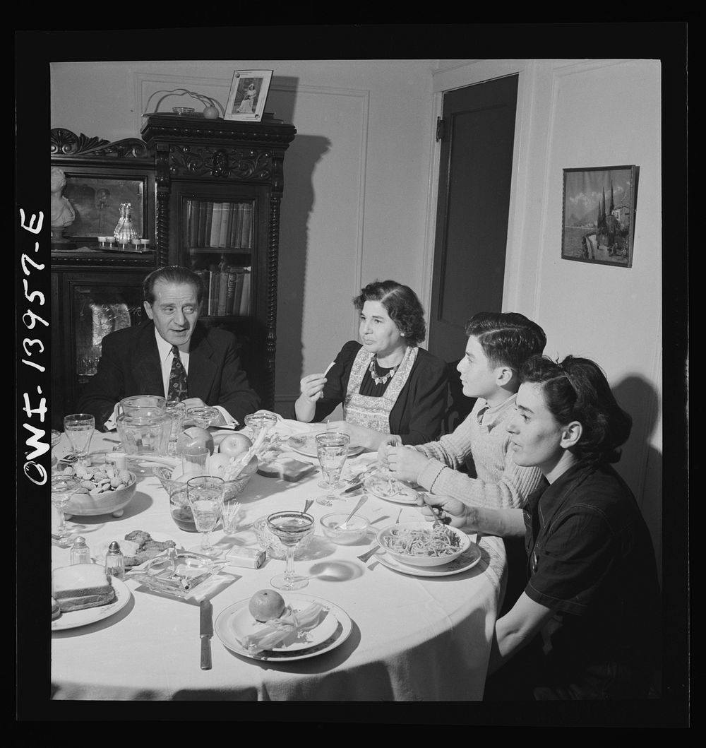 Corona, Long Island, New York. Raymond [i.e. Vincenzo] Fazio family at supper. Defense worker Jerry, the daughter, has just…