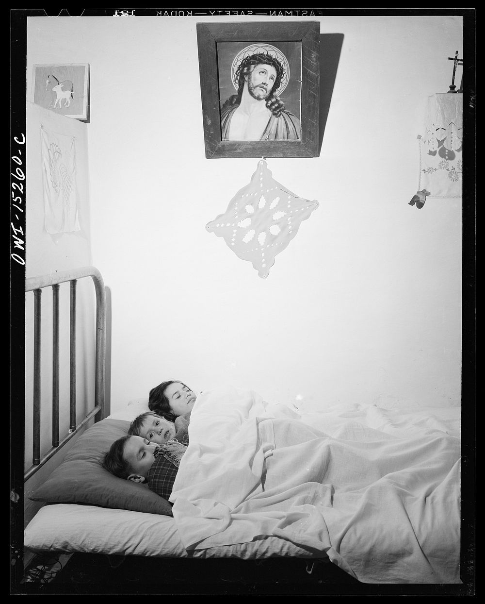 Trampas, New Mexico. In many Spanish-American homes, mattresses are rolled out on the floor at night. But by putting three…