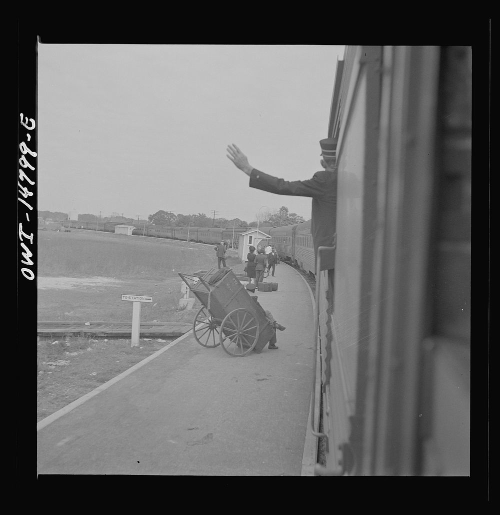 Saint Augustine, Florida. Trainman signalling from a "Jim Crow" coach. Sourced from the Library of Congress.