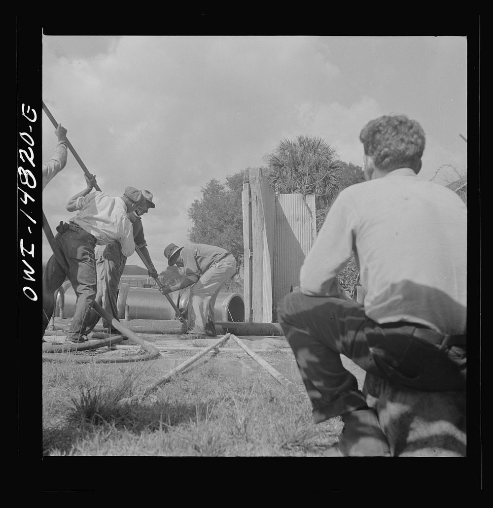 Daytona Beach, Florida. A foreman watching a  workman prepare to lay a sewer pipeline. Sourced from the Library of Congress.