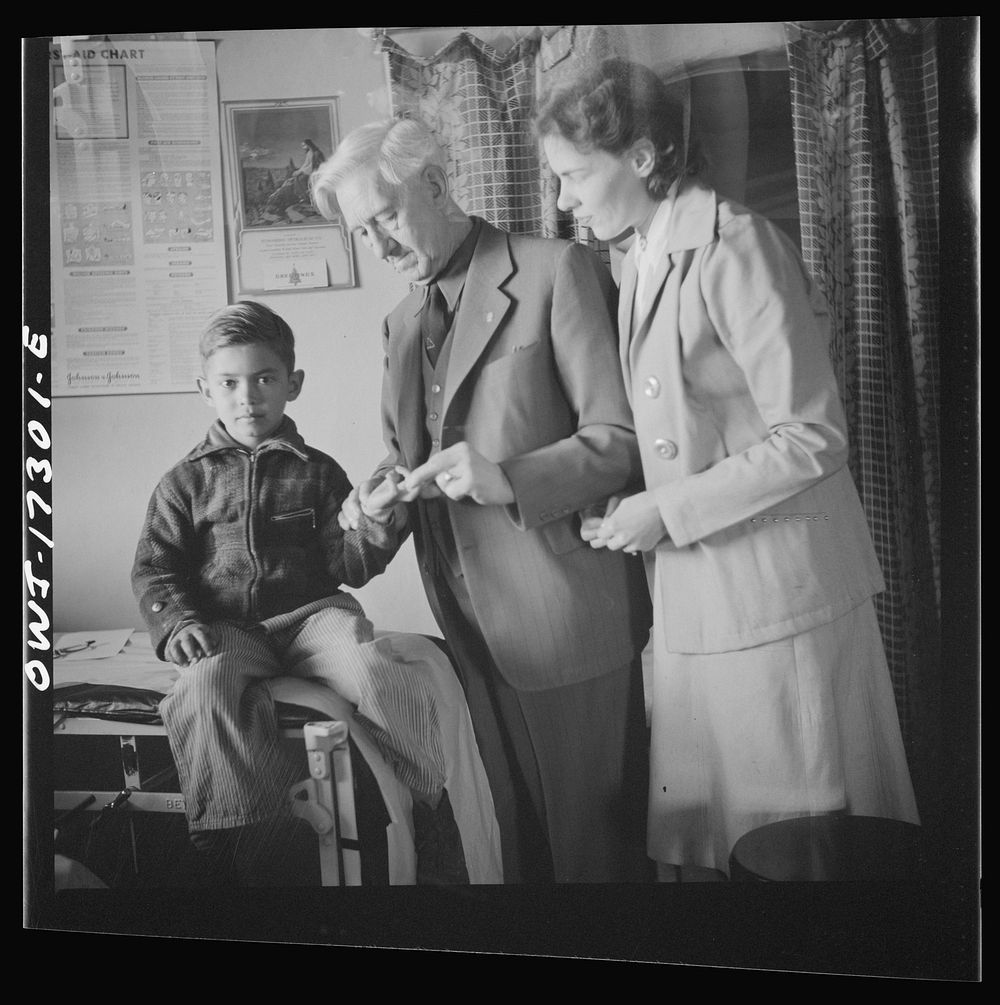 [Untitled photo, possibly related to: Penasco, New Mexico. Doctor Onstine, medical doctor, making an examination in the…