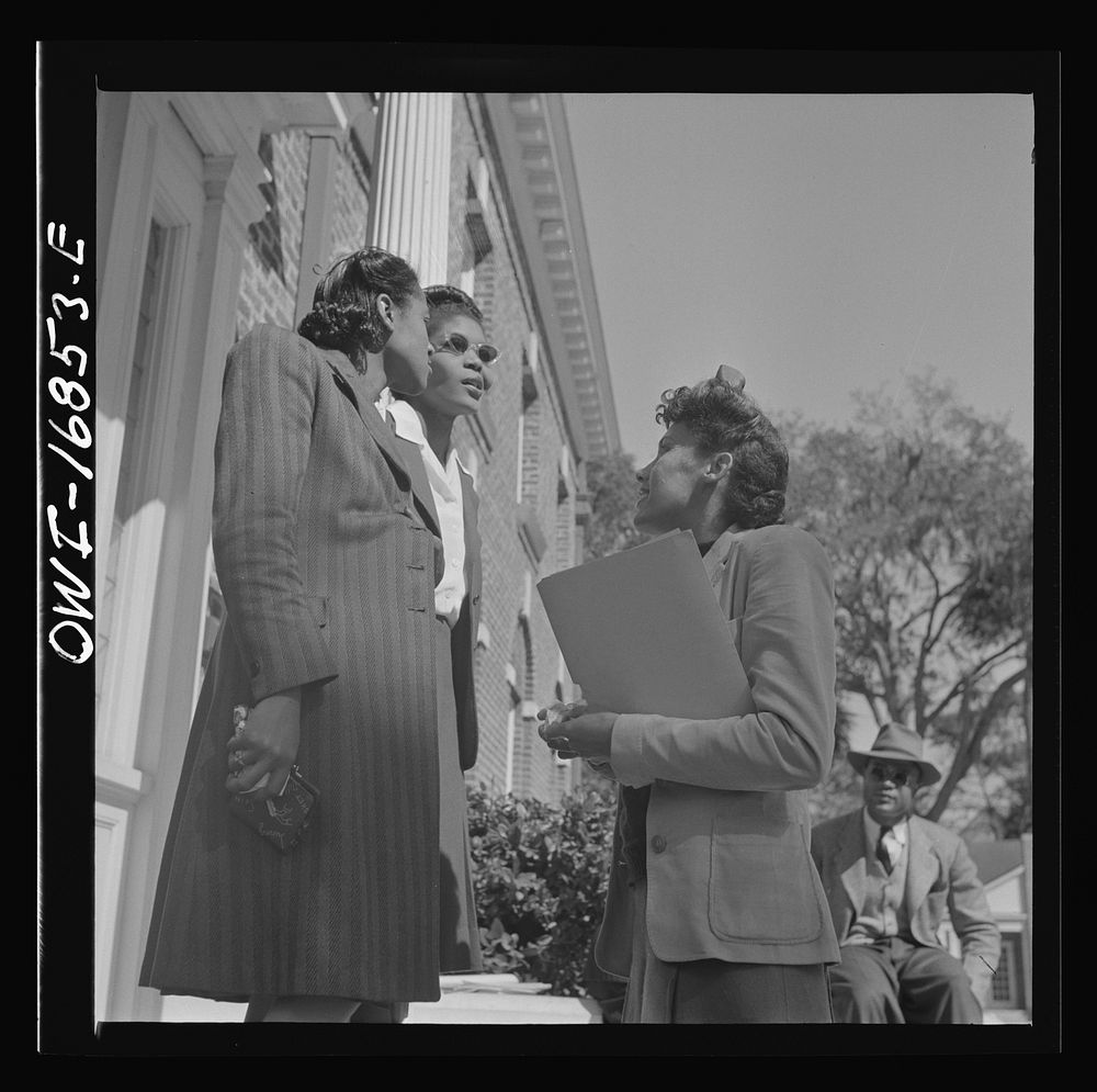 [Untitled photo, possibly related to: Daytona Beach, Florida. Bethune-Cookman College. Two teachers having a conversation on…
