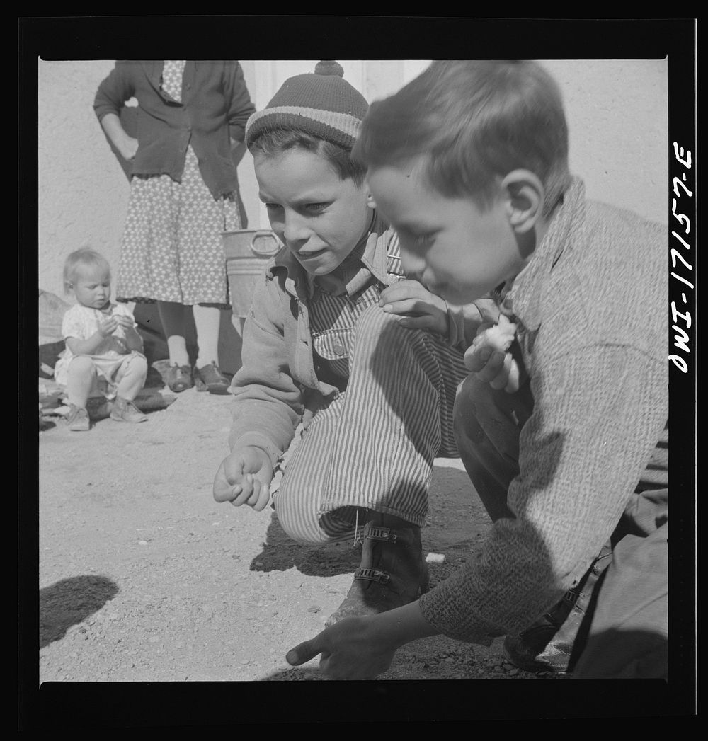 [Untitled photo, possibly related to: Trampas, New Mexico. Playing marbles in the dooryard of the home of Juan Lopez, the…