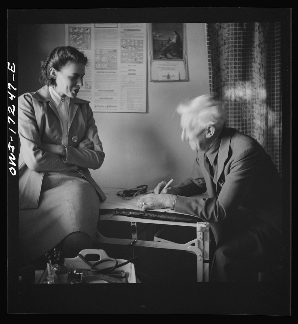 [Untitled photo, possibly related to: Penasco, New Mexico. Doctor Onstine, medical doctor, writing a prescription in the…