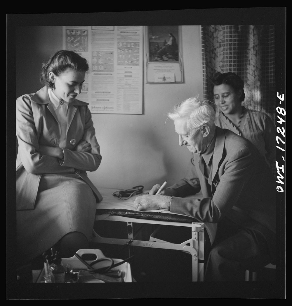 Penasco, New Mexico. Doctor Onstine, medical doctor, writing a prescription in the clinic operated by the Taos County…
