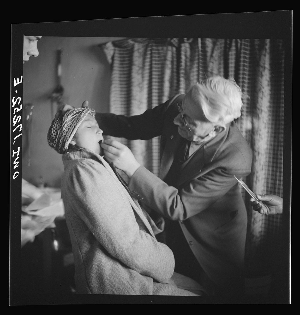 [Untitled photo, possibly related to: Penasco, New Mexico. Doctor Onstine, medical doctor, making an examination in the…