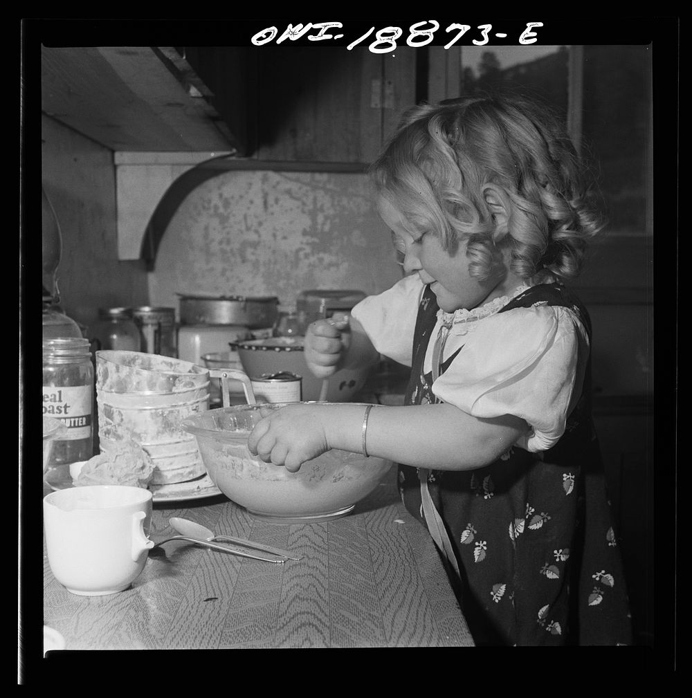 Moreno Valley, Colfax County, New Mexico. George Mutz's youngest daughter helping with the cooking. Sourced from the Library…