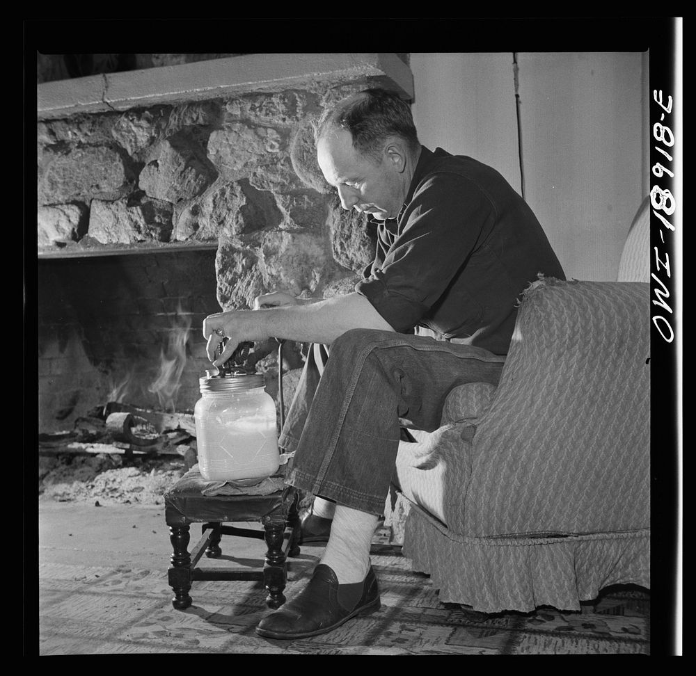Moreno Valley, Colfax County, New Mexico. William Heck, a stockman, churning butter after a hard day in the saddle. Sourced…