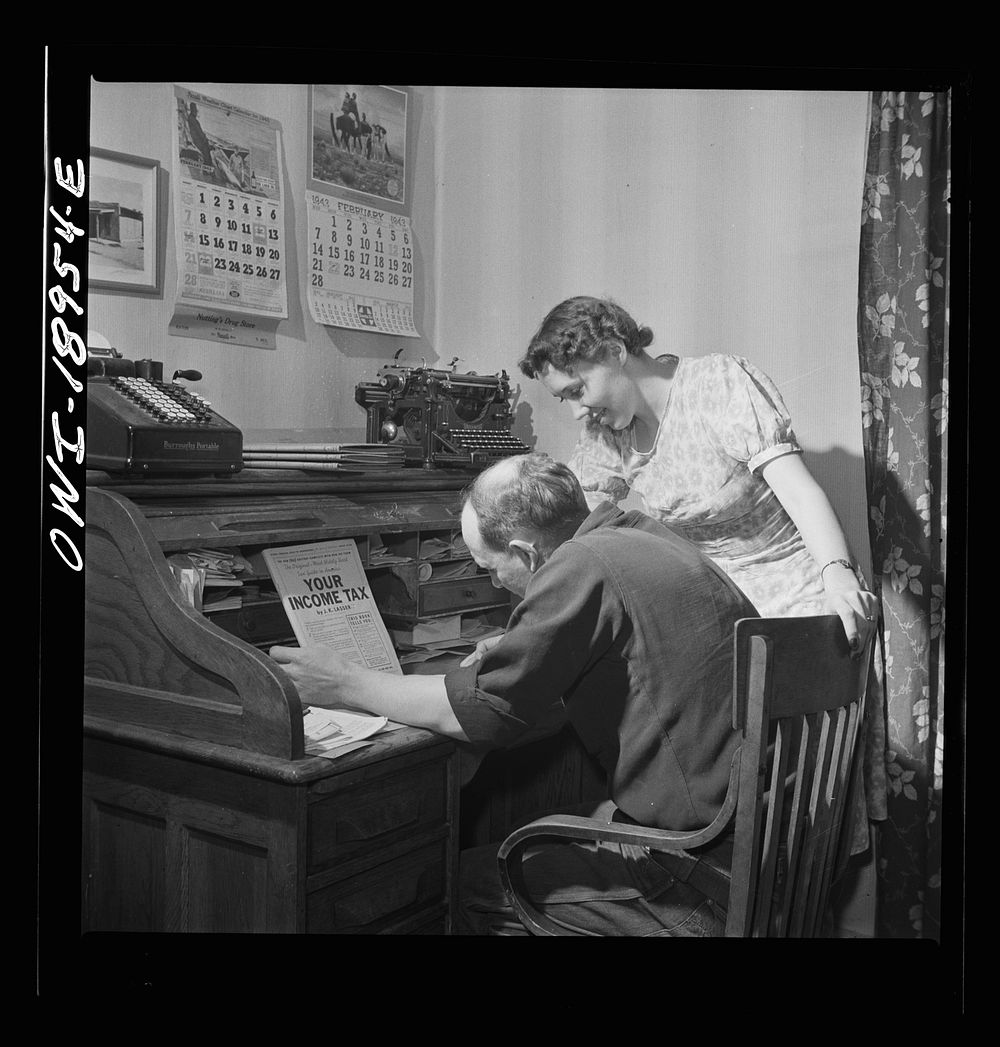 Moreno Valley, Colfax County, New Mexico. William Heck, a cattleman, and his wife making out their income tax form. Sourced…