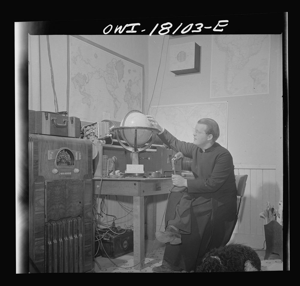 Questa, New Mexico. Father Smith broadcasting a news release in Spanish from his parish house broadcasting station. Sourced…