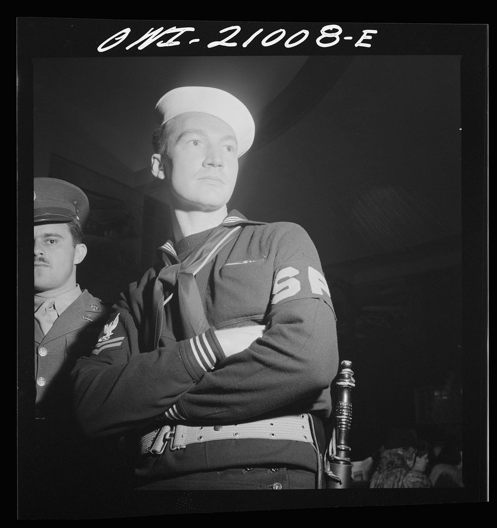 Washington, D.C. Member of the Shore Patrol who helps get servicemen lined up and in order while waiting for special buses…
