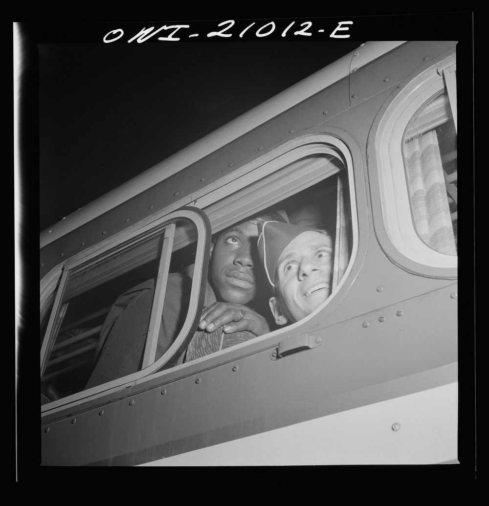 Washington, D.C. Soldiers looking out the window of the bus just before leaving the Greyhound terminal. Sourced from the…