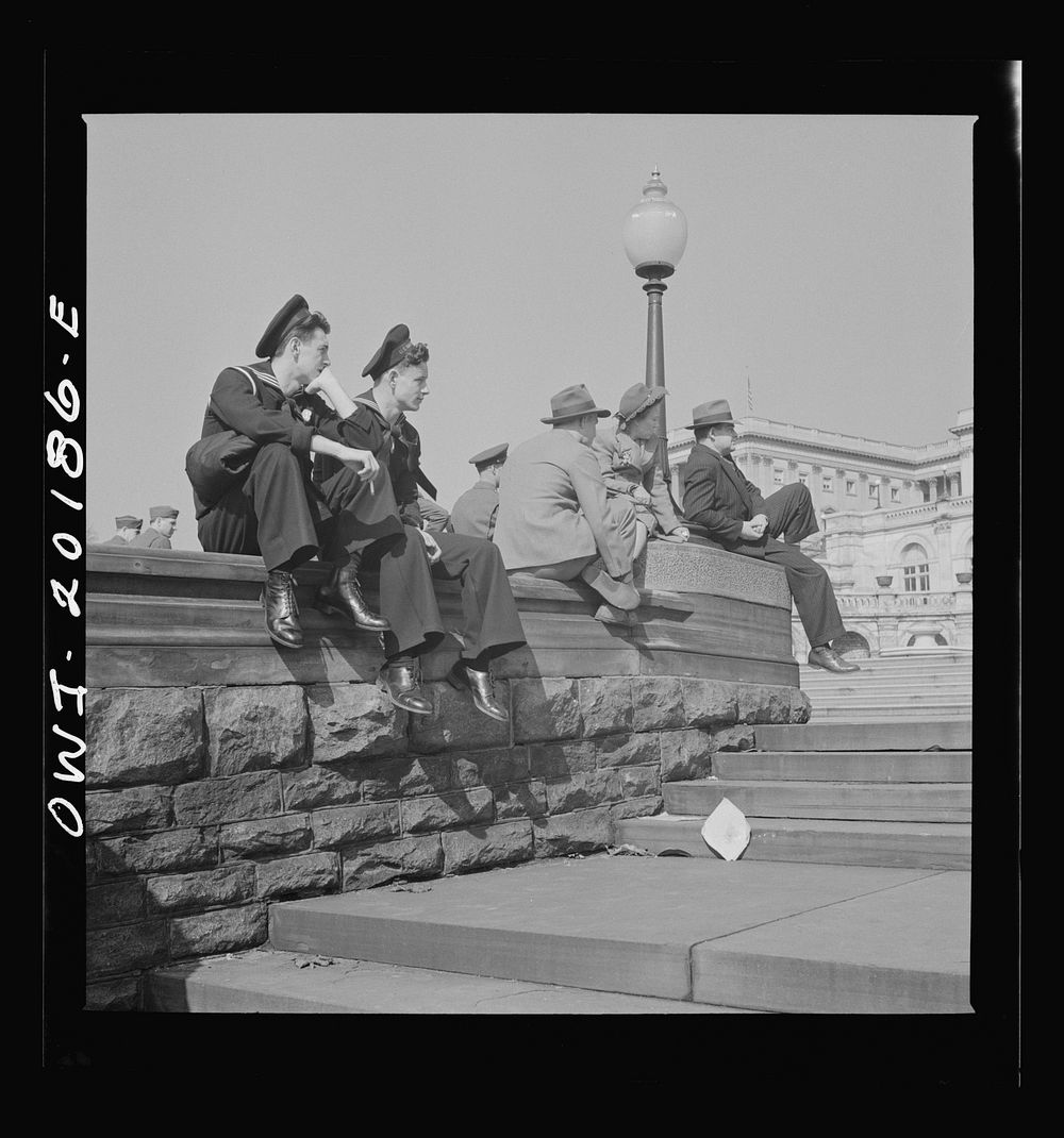 Washington, D.C. Sailors and civilians sitting on the Capitol grounds. Sourced from the Library of Congress.