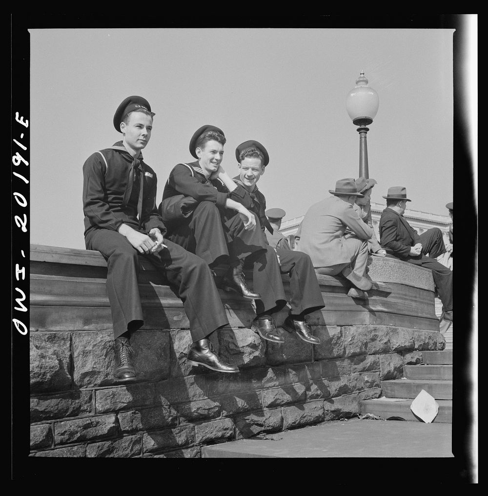 Washington, D.C. Sailors and civilians sitting on the Captiol grounds. Sourced from the Library of Congress.