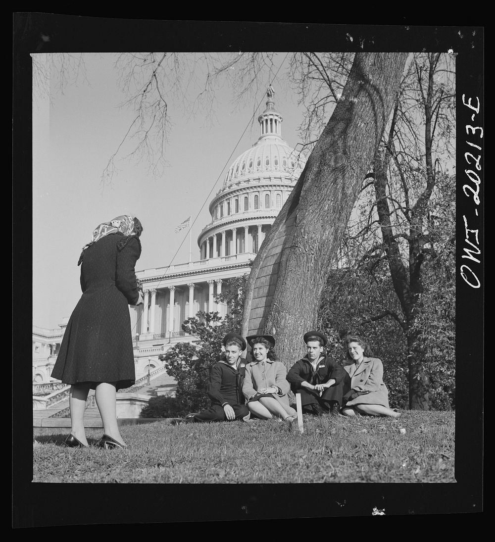 Washington, D.C. Taking pictures of the Capitol lawn on a Sunday afternoon. Sourced from the Library of Congress.