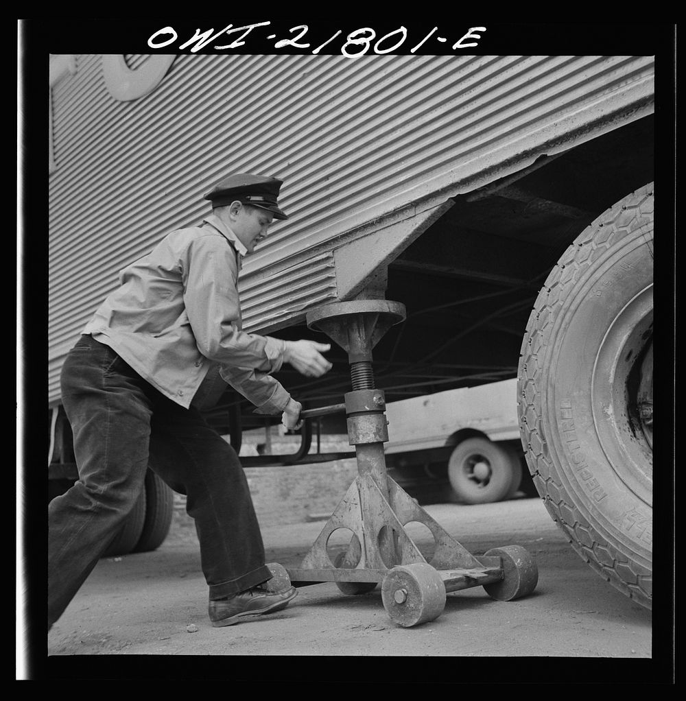 Greenville, South Carolina. Loading platform at the terminal of the Associated Transport Company. Putting jacks under a…