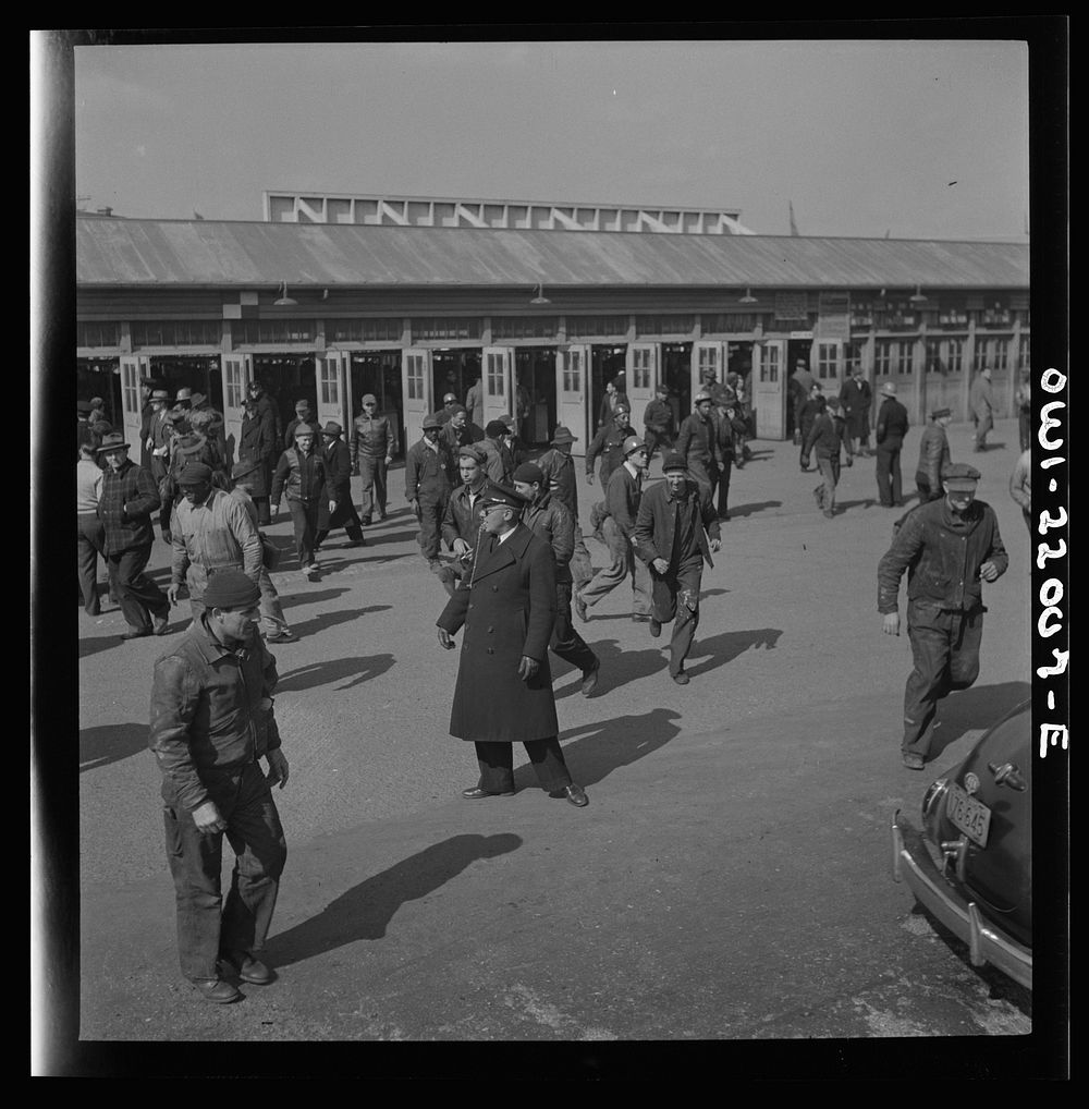 [Untitled photo, possibly related to: Baltimore, Maryland. Workers hurrying to catch a trolley and a trackless trolley at…